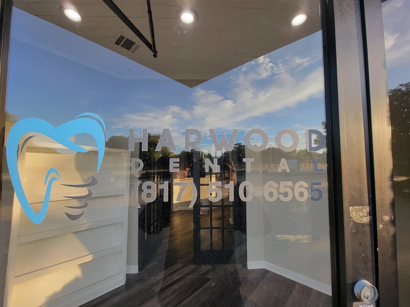 The glass front door with the Harwood Family Dental logo